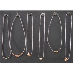 SIX LIQUID SILVER AND SHELL CHOKERS