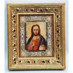 An antique Russian icon. Heavily carved gilt...