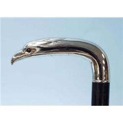 An ebonized mahogany walking stick. Silver ha...