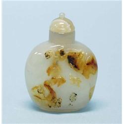 A good Chinese agate snuff bottle carved with...