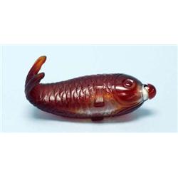 An unusual Chinese red glass bottle in the fo...