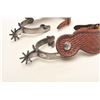 Image 2 : Pair of un-marked inlaid spurs with tooled  leather straps; nicely accomplished.      Est.:  $150-$3