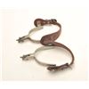 Image 1 : Pair of steel silver spurs with tooled  leather straps; consignor indicates Crescent  City Prison or