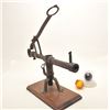 Image 2 : Antique iron glass target ball thrower on  wood display base with two glass target  balls, one marke