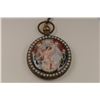 Image 2 : Brass cased fancy pocket watch with two sided  color designs of a woman on one side and a  man and w