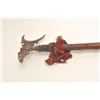 Indonesian pole arm; ornate brass head, brass  tacked wood shaft; unknown age.     Est.:   $100-$150