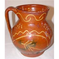 Slip decorated redware pitcher