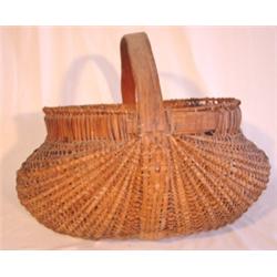 Large primitive woven buttocks basket