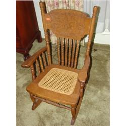 Ornate oak child's cane bottom rocking chair