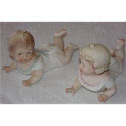 Pair of porcelain bisque piano babies