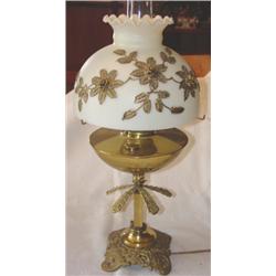 Ornate brass table lamp with floral decorated shade