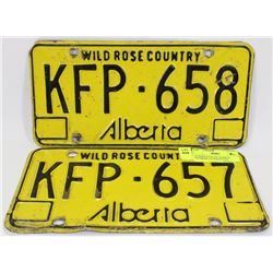 2 CONSECUTIVE #'D ALBERTA WILDROSE LICENSE PLATES