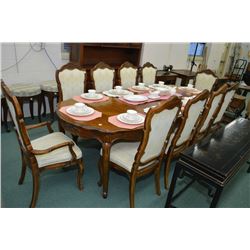 Quality oak dining room table with two skirted insert leafs and ten dining chairs with carved backs 