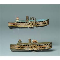 LOT OF TWO C. I. PADDLE BOATS