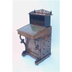 A Victorian rosewood davenport, having metamorphic superstructure with fret-carved gallery and fi...