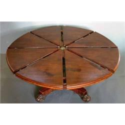 A good Johnstone & Jeanes patent mahogany circular extending dining table, circa 1845, having mou...
