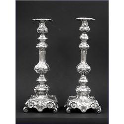 PAIR OF SILVER PLATED CANDLESTICKS, Probably Polish. 19th Century. The square foliate base with...