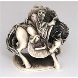 CARVED IVORY NETSUKE, Japanese. Circa 1900. Signed. Of an elder riding a horse with a giant pea...