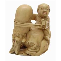 CARVED IVORY NETSUKE, Japanese. Late 19th Century. Signed. Of Fukurokuju on his hands and knees...