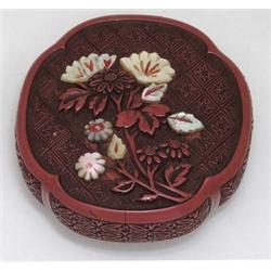 RED CINNABAR MANJU, Japanese. Circa 1900. Signed. Of circular form, one side carved and overlai...
