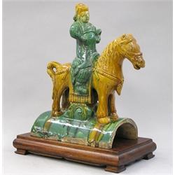 MING GLAZED POTTERY EQUESTRIAN ROOF TILE, Chinese. Ming Dynasty. 1368-1644. Modeled as a long r...