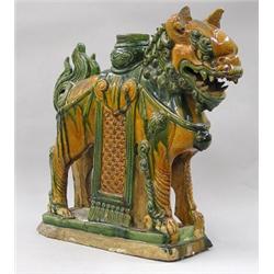 MING GLAZED POTTERY ROOF ORNAMENT, Chinese. Ming Dynasty. 1368-1644. Modeled as a fu lion stand...