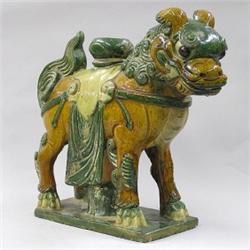 MING GLAZED POTTERY ROOF ORNAMENT, Chinese. Ming Dynasty. 1368-1644. Modeled as a fu lion drape...