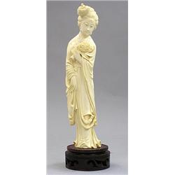 CARVED IVORY FIGURE OF A BEAUTY, Chinese. Signed. In a standing position holding a chrysanthemu...