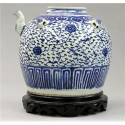 BLUE AND WHITE PORCELAIN JAR, Chinese. 18th Century. Molded with a spout and four masks, painte...