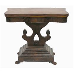 EMPIRE CHERRY AND FIGURAL MAHOGANY FOLD OVER CARD TABLE, American. Circa 1865. The serpentine f...