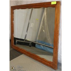 A MIRROR IN A WOODEN FRAME 41” X 29”