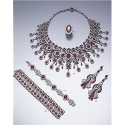 A DIAMOND AND RUBY CLUSTER RING SET TO THE CENTER WITH A MARQUISE SHAPED DIAMOND, TO A TWO TIE