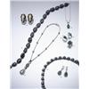 Image 1 : AN UNUSUAL BLACK JADEITE AND DIAMOND NECKLACE COMPOSED OF 18 OVAL SHAPED POLISHED BLACK JADEIT