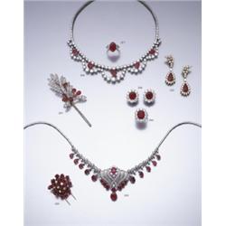 A RUBY AND DIAMOND CLIP BROOCH CLAW SET THROUGHOUT WITH CARVED RUBY LEAVES INTERSPERSED WIT