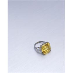 A MAGNIFICENT FANCY VIVID YELLOW DIAMOND RING THE FANCY VIVID YELLOW SQUARE EMERALD-CUT DIAMON...