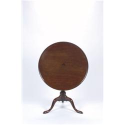 A GEORGE III MAHOGANY TILT-TOP TABLE, the circular top on a baluster turned support to tripod bas...