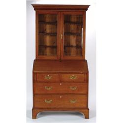 AN ANTIQUE OAK BUREAU BOOKCASE, in the George III manner, the upper section having double full le...