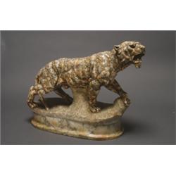 ALABASTER STUDY OF A TIGER, with glass inset eyes, striding forward on a rocky, outcrop , l. 23...