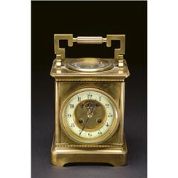 FRENCH BRASS CASED LARGE CARRIAGE CLOCK, the movement fronted by a white enamel dial, the top ins...