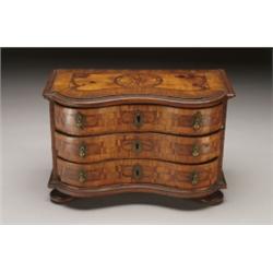 CONTINENTAL PARQUETRY INLAID WALNUT MINIATURE SERPENTINE COMMODE, the inlaid moulded top with sta...