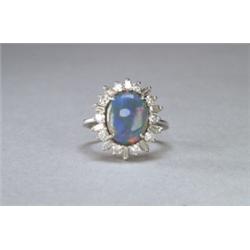 PLATINUM COCKTAIL RING, set with an oval black opal, cabochon (11.4mm x 9.0mm x 4.6mm) encircle...