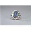 Image 1 : PLATINUM COCKTAIL RING, set with an oval black opal, cabochon (11.4mm x 9.0mm x 4.6mm) encircle...