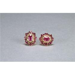 PAIR OF 18K YELLOW GOLD STUD EARRINGS, each set with an oval cut ruby within a, scallop-edged b...