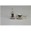 Image 1 : PAIR OF 14K YELLOW GOLD AND SILVER HOOK BACK EARRINGS, each bezel set with an oval cut sapphire (...