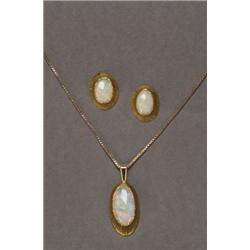 18K YELLOW GOLD, CONTEMPORARY PENDANT, bezel set with a fine oval opal cabochon, and suspended...