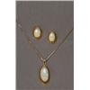Image 1 : 18K YELLOW GOLD, CONTEMPORARY PENDANT, bezel set with a fine oval opal cabochon, and suspended...