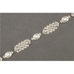18K WHITE GOLD FILIGREE BRACELET, formed of panels, of 3 rows of cultured pearls, separated b...