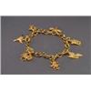 Image 1 : 18K YELLOW GOLD CHARM BRACELET, with seven 18k, yellow gold charms depicting, animals and set...