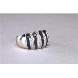 18K WHITE GOLD WIDE BAND, channel set with 28 square cut sapphires (approx. 2.25ct. total weight)...