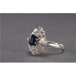 18K WHITE GOLD COCKTAIL RING, set with an oval cut, sapphire (approx. 1.70ct.), encircled by...
